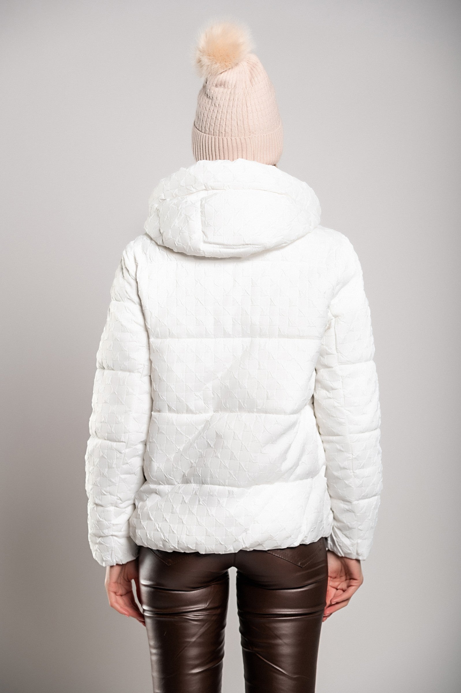 White short padded jacket with hood, featuring a high collar and zipped side pockets, perfect for winter wear.