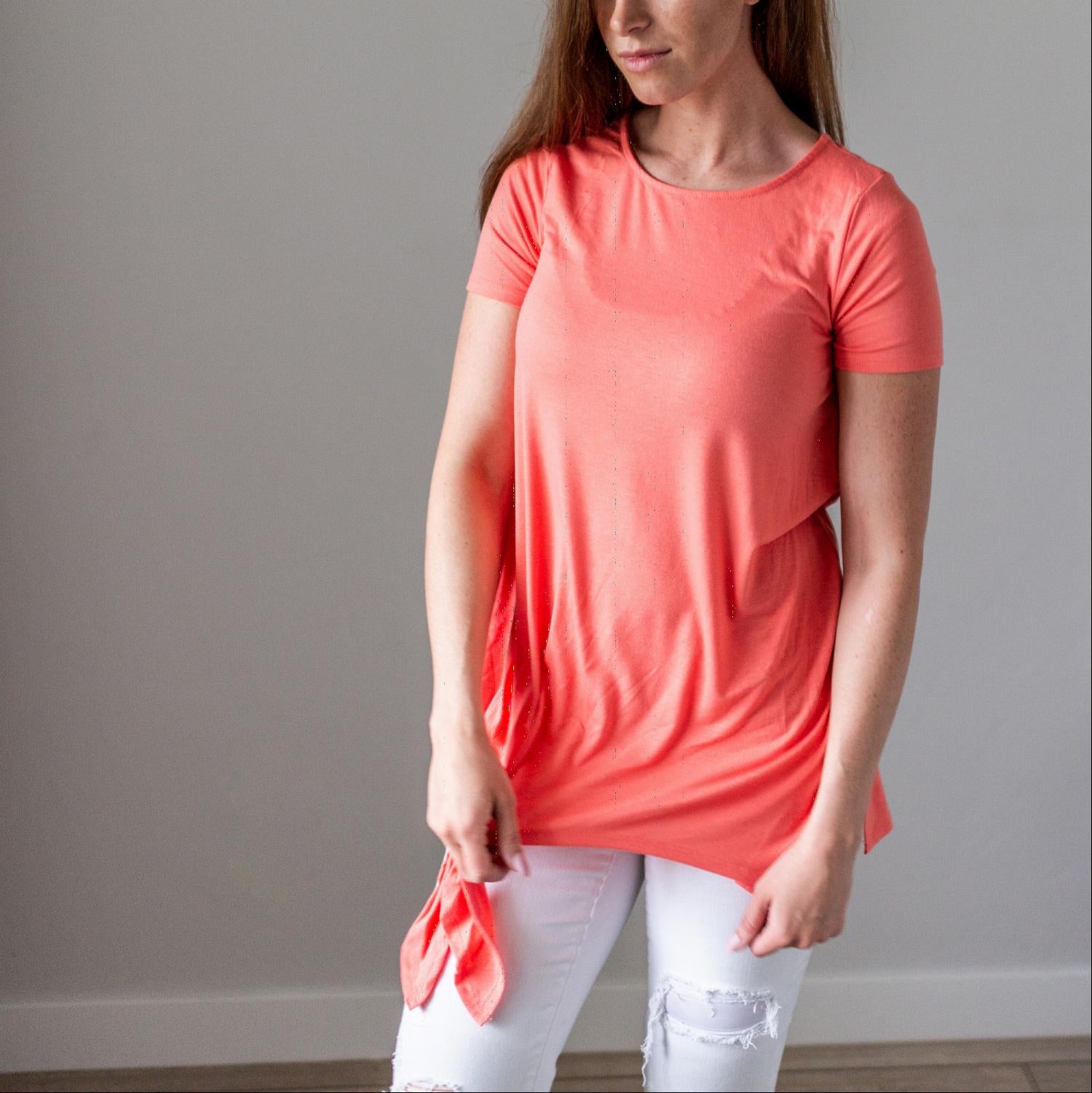 Woman wearing coral shirt, white pants