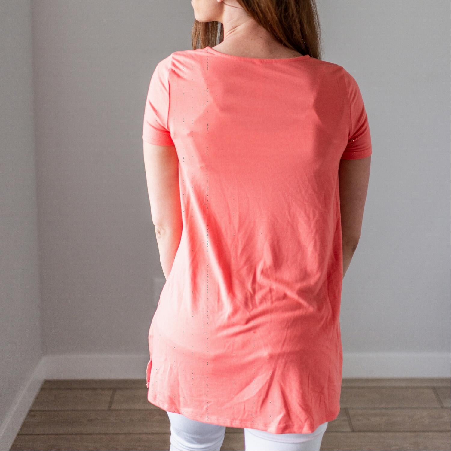 Person in coral top, back view.