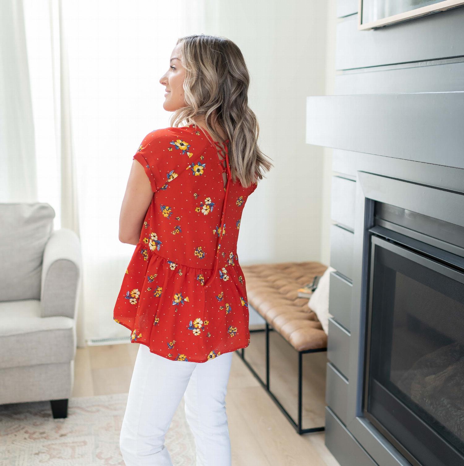 A vibrant short sleeve floral print top featuring a lace-up back detail, perfect for casual outings.