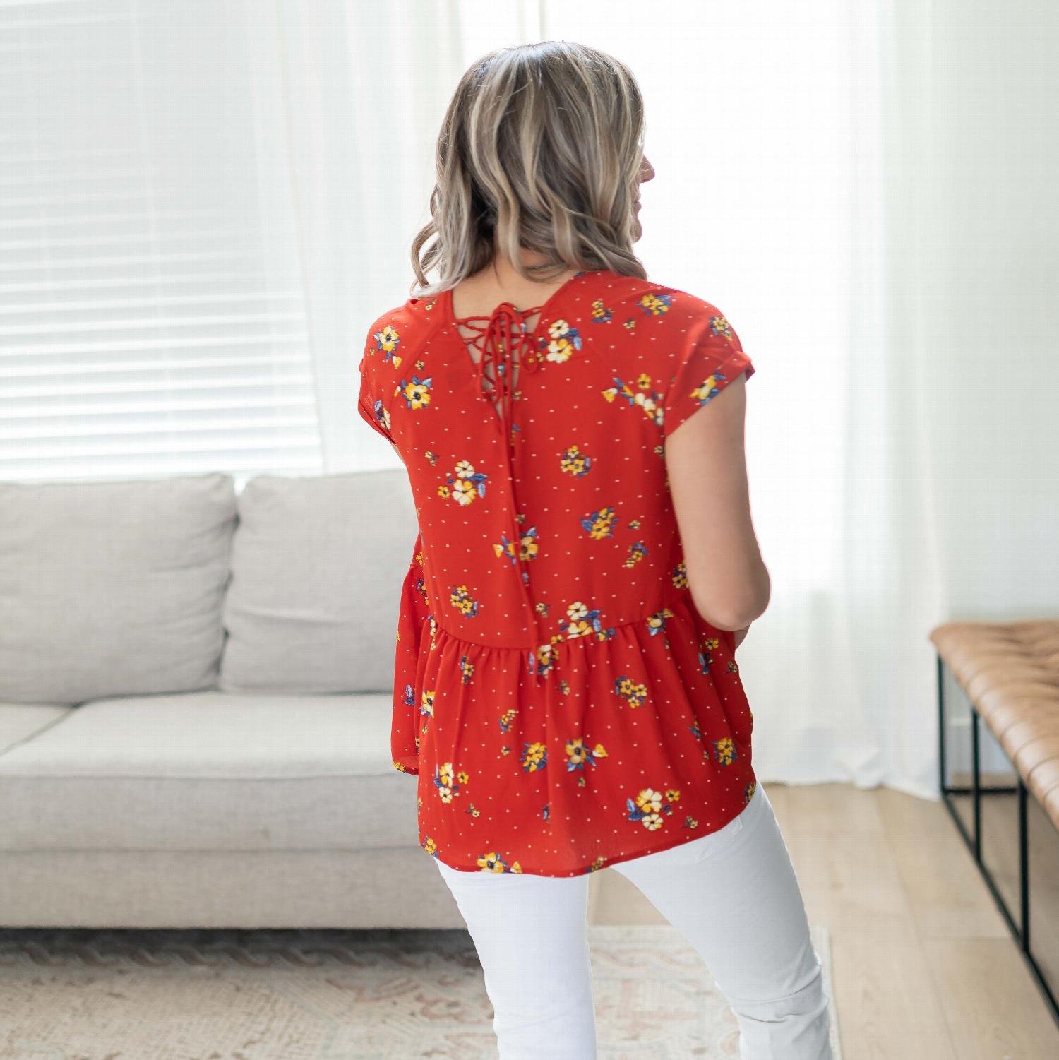 A vibrant short sleeve floral print top featuring a lace-up back detail, perfect for casual outings.