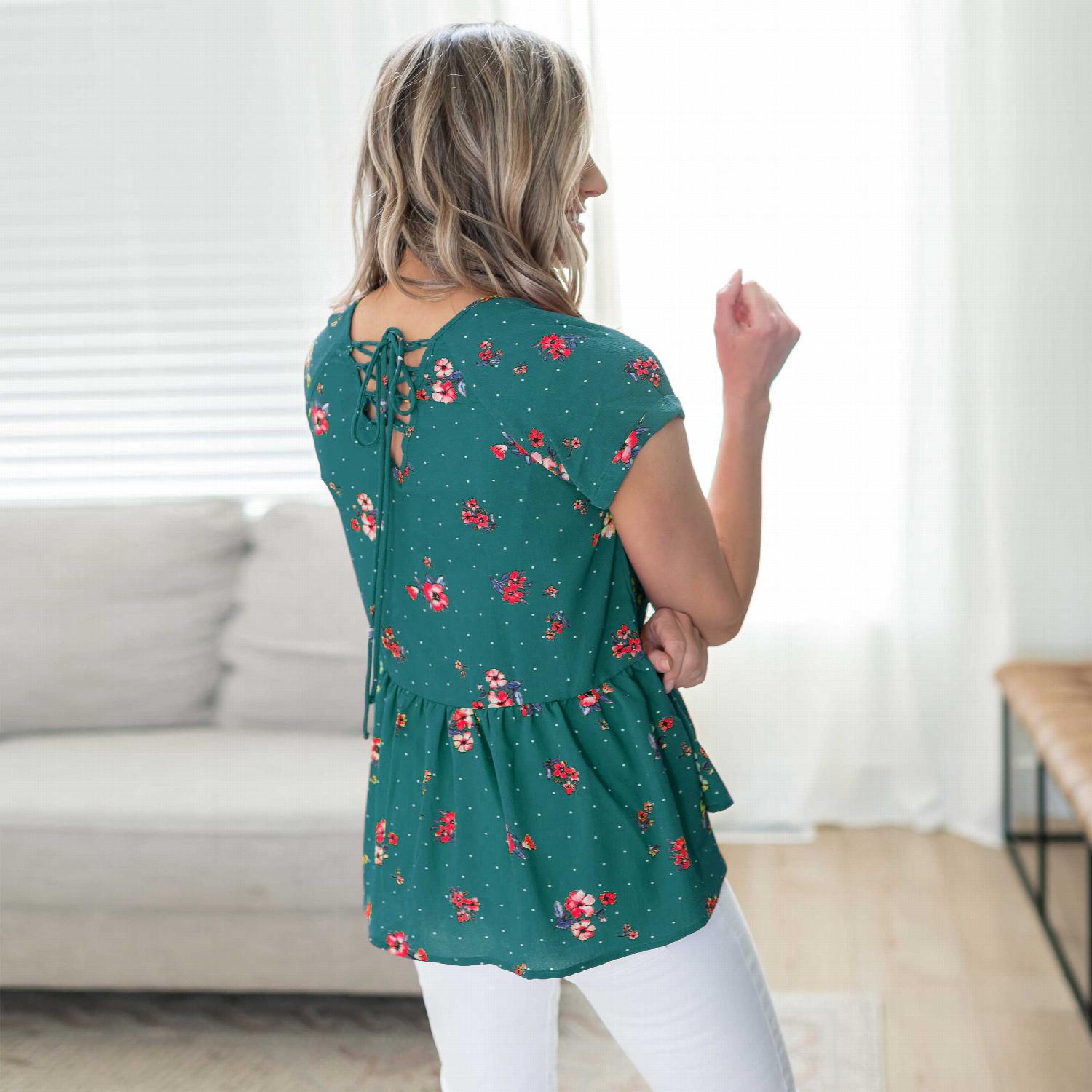 A vibrant short sleeve floral print top featuring a lace-up back detail, perfect for casual outings.