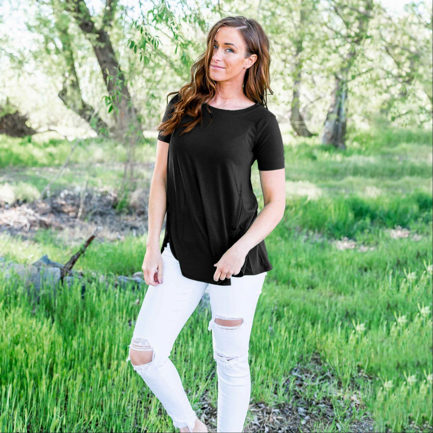 A stylish loose-fitting short sleeve top with a modest scoop neck, rounded hemline, and decorative side buttons, perfect for casual wear.