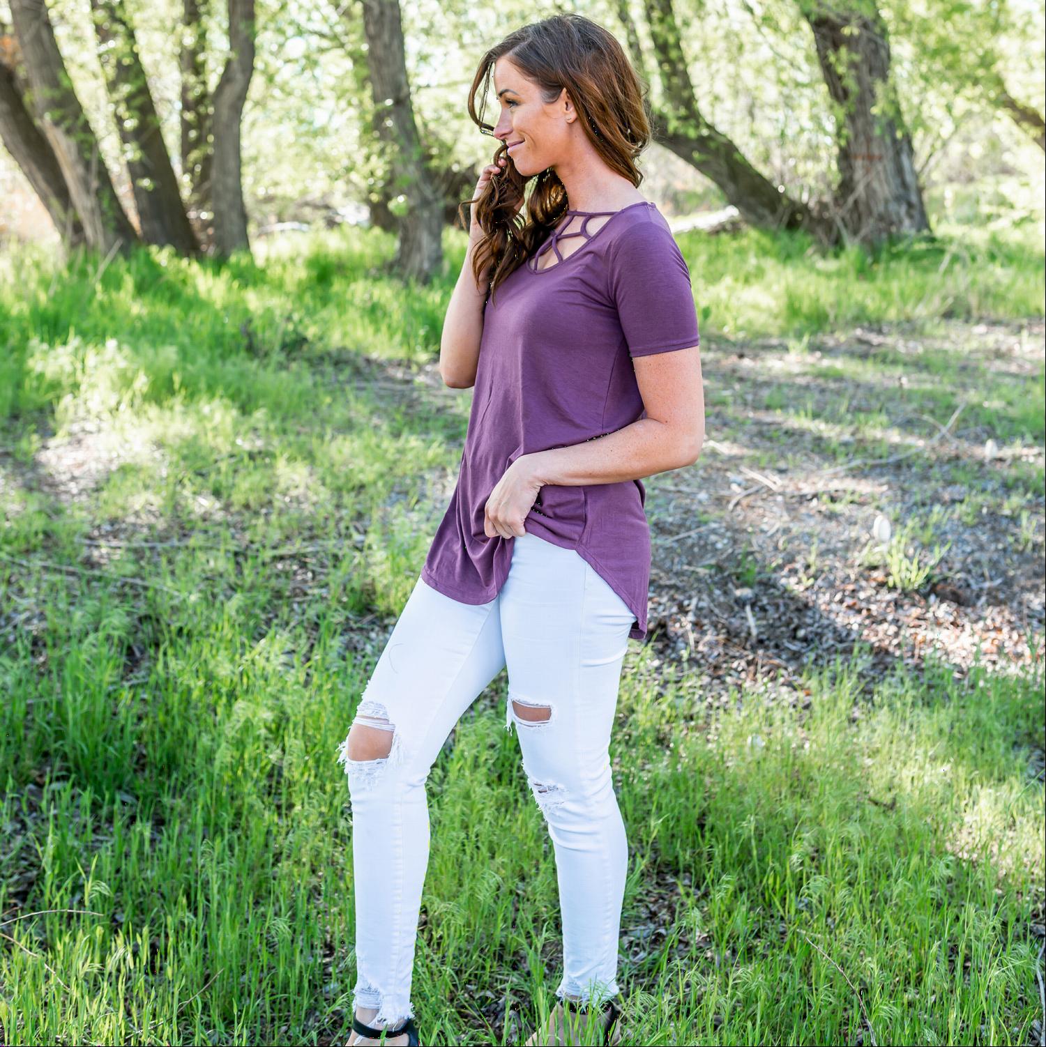 A stylish short sleeve top featuring a unique web cut-out design, perfect for casual and chic outfits.