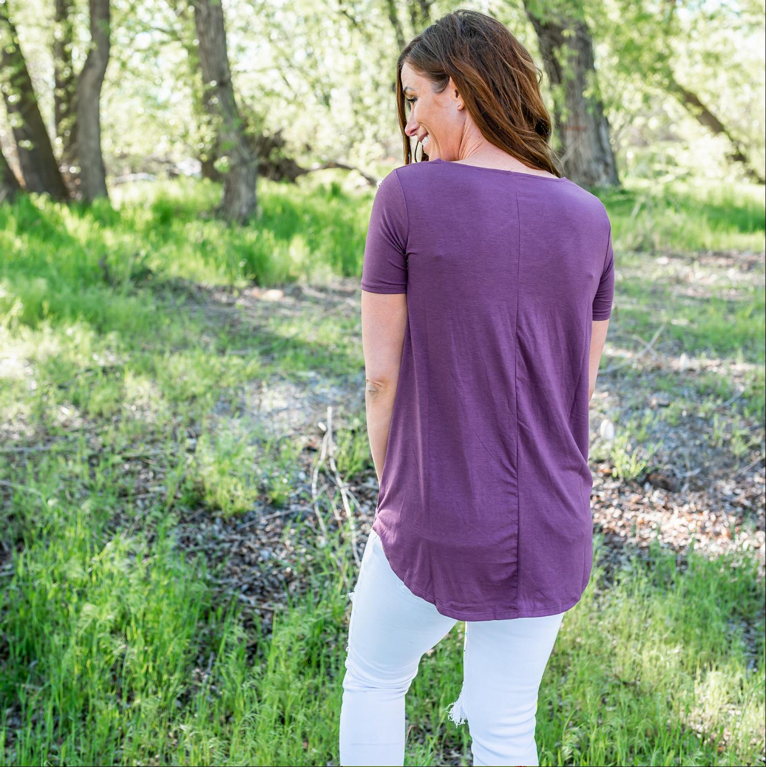 A stylish short sleeve top featuring a unique web cut-out design, perfect for casual and chic outfits.