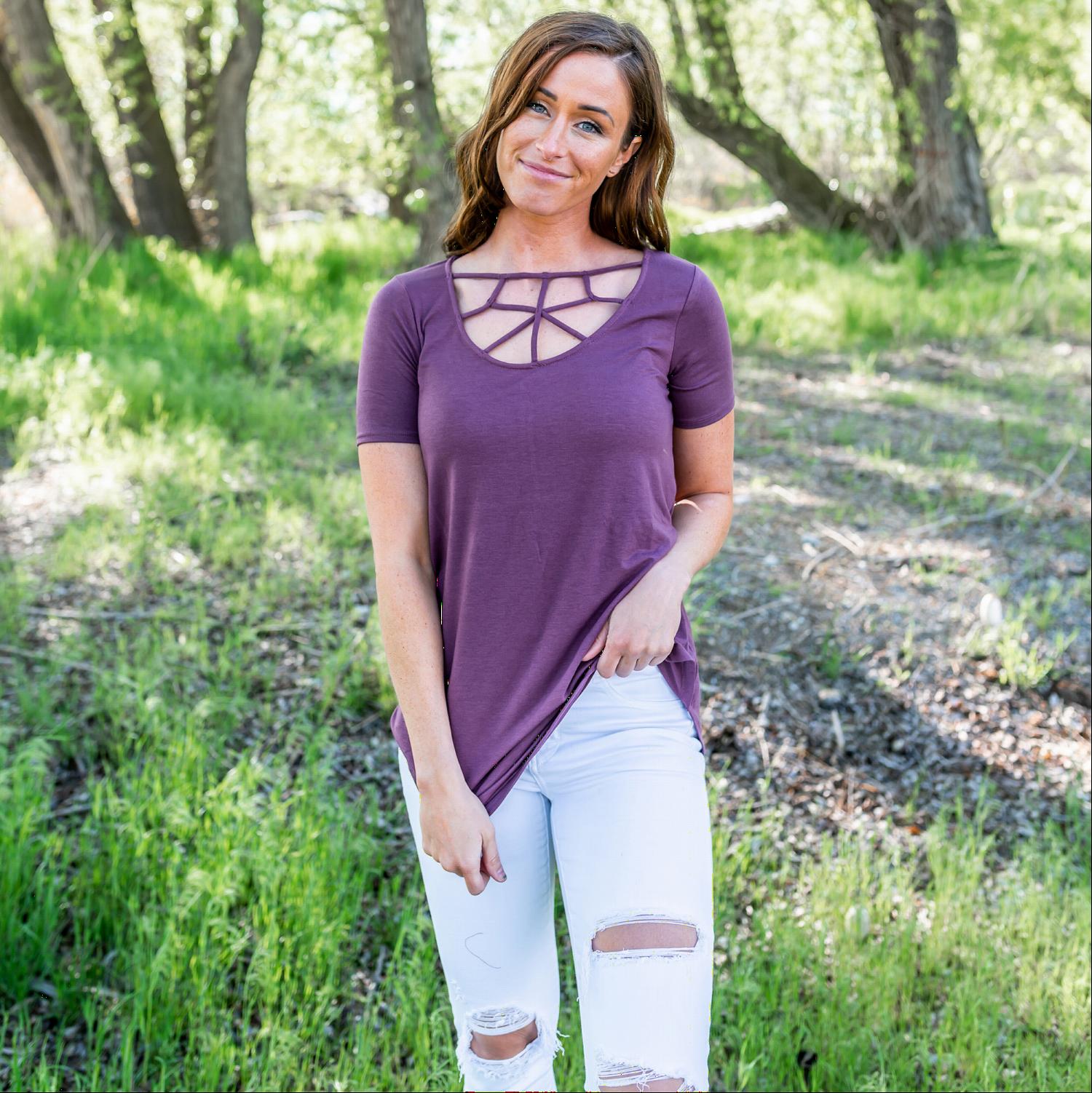 A stylish short sleeve top featuring a unique web cut-out design, perfect for casual and chic outfits.