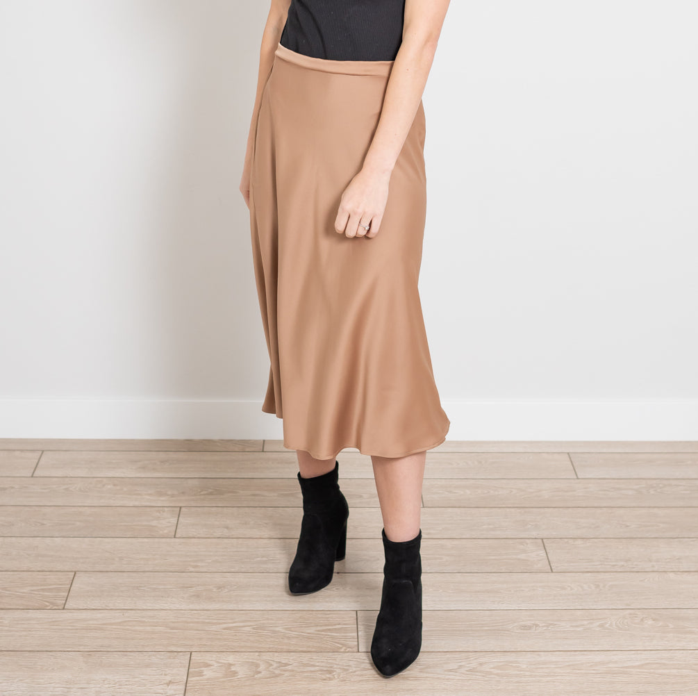 A stylish Side Zip Midi Silk Skirt in elegant silk fabric, showcasing its sleek design and flattering silhouette.