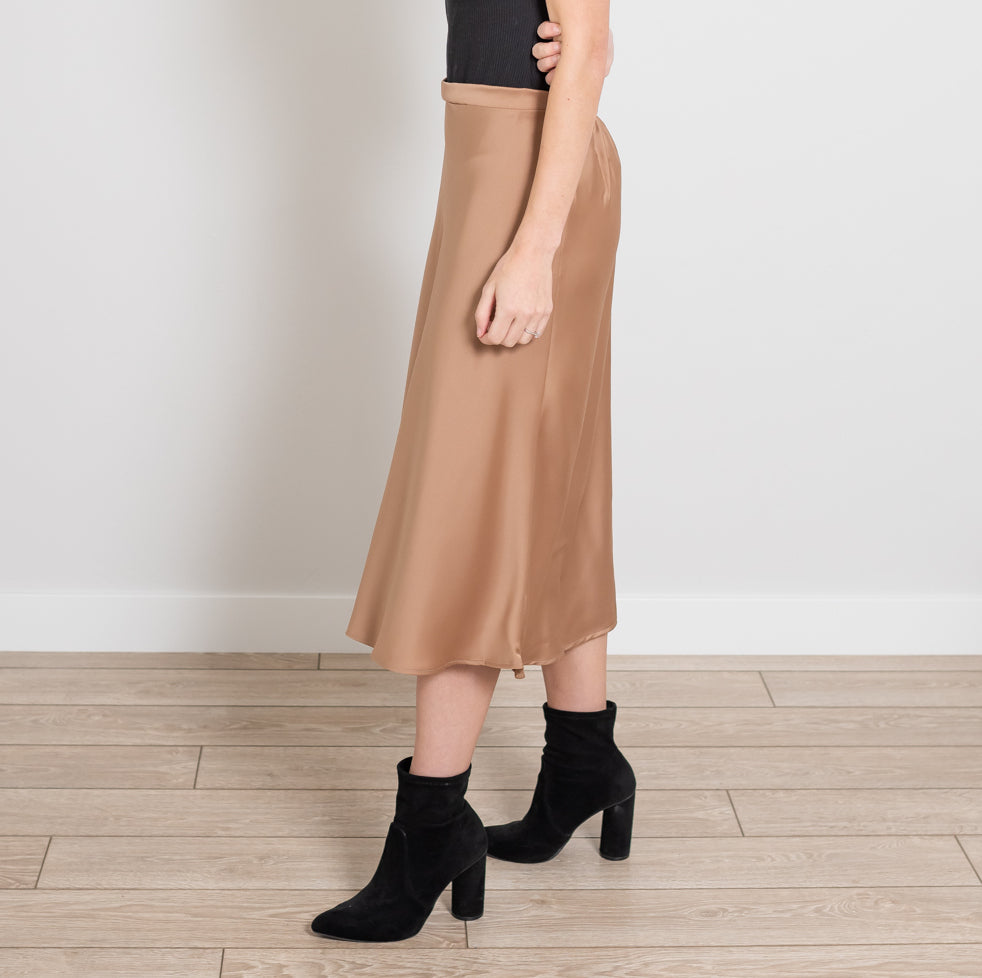 A stylish Side Zip Midi Silk Skirt in elegant silk fabric, showcasing its sleek design and flattering silhouette.