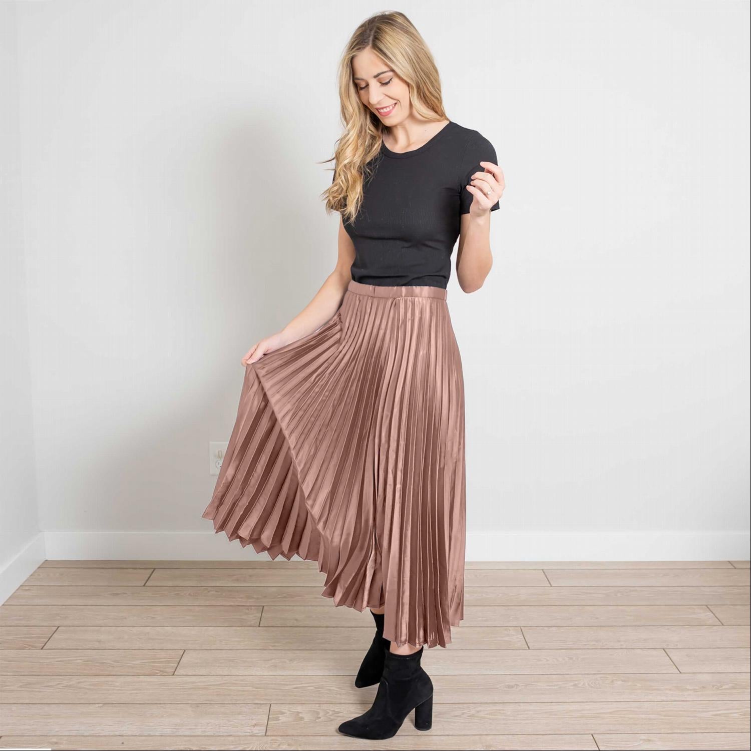 A beautiful side zip pleated silk midi skirt in a soft, elegant fabric, showcasing its pleats and stylish design.