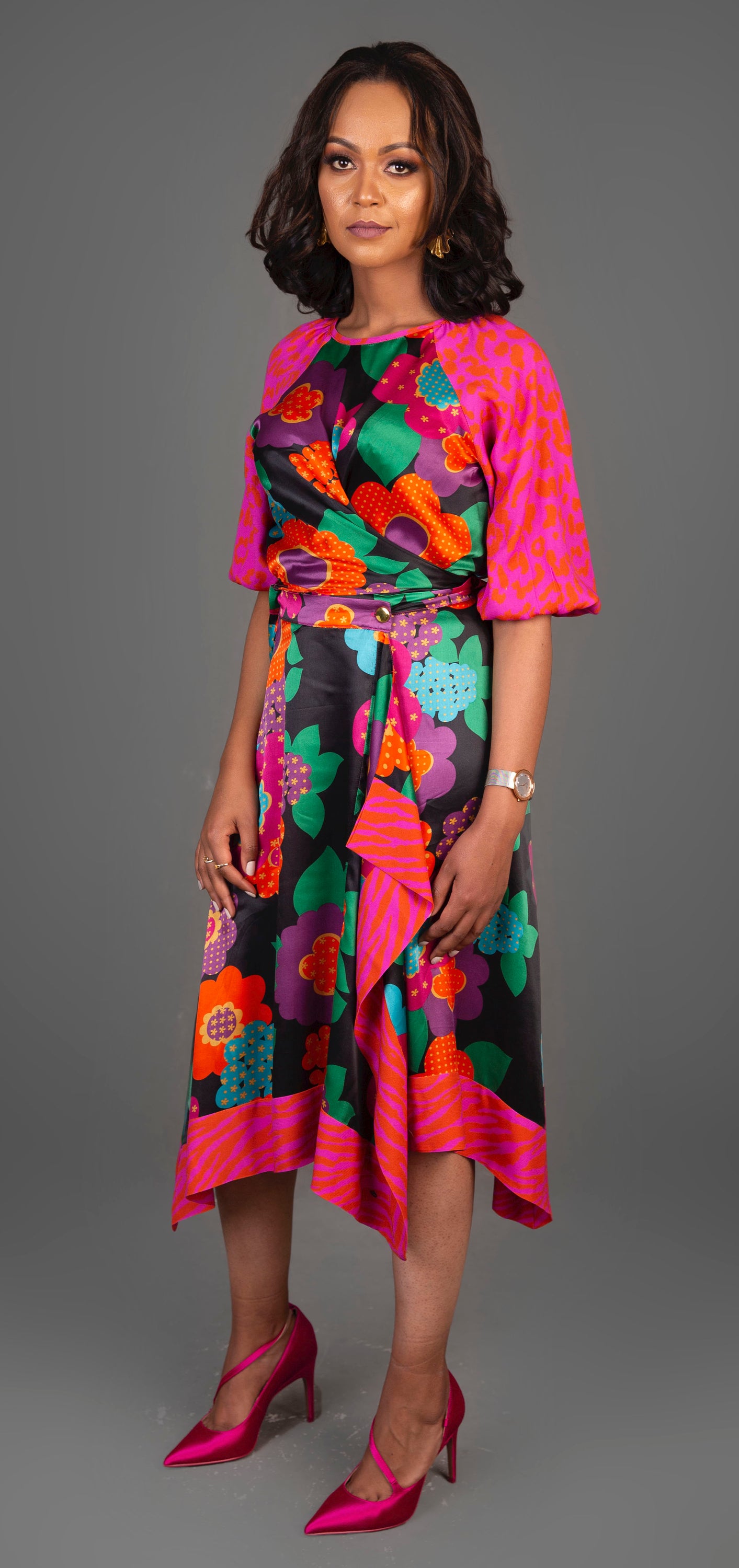 A stylish two-piece wrap dress featuring bold floral and leopard prints, crafted from luxurious satin viscose material.