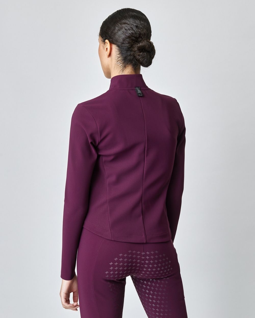 Burgundy Signature Riding Jacket made from Italian jersey fiber, featuring a fitted silhouette and concealed pockets.