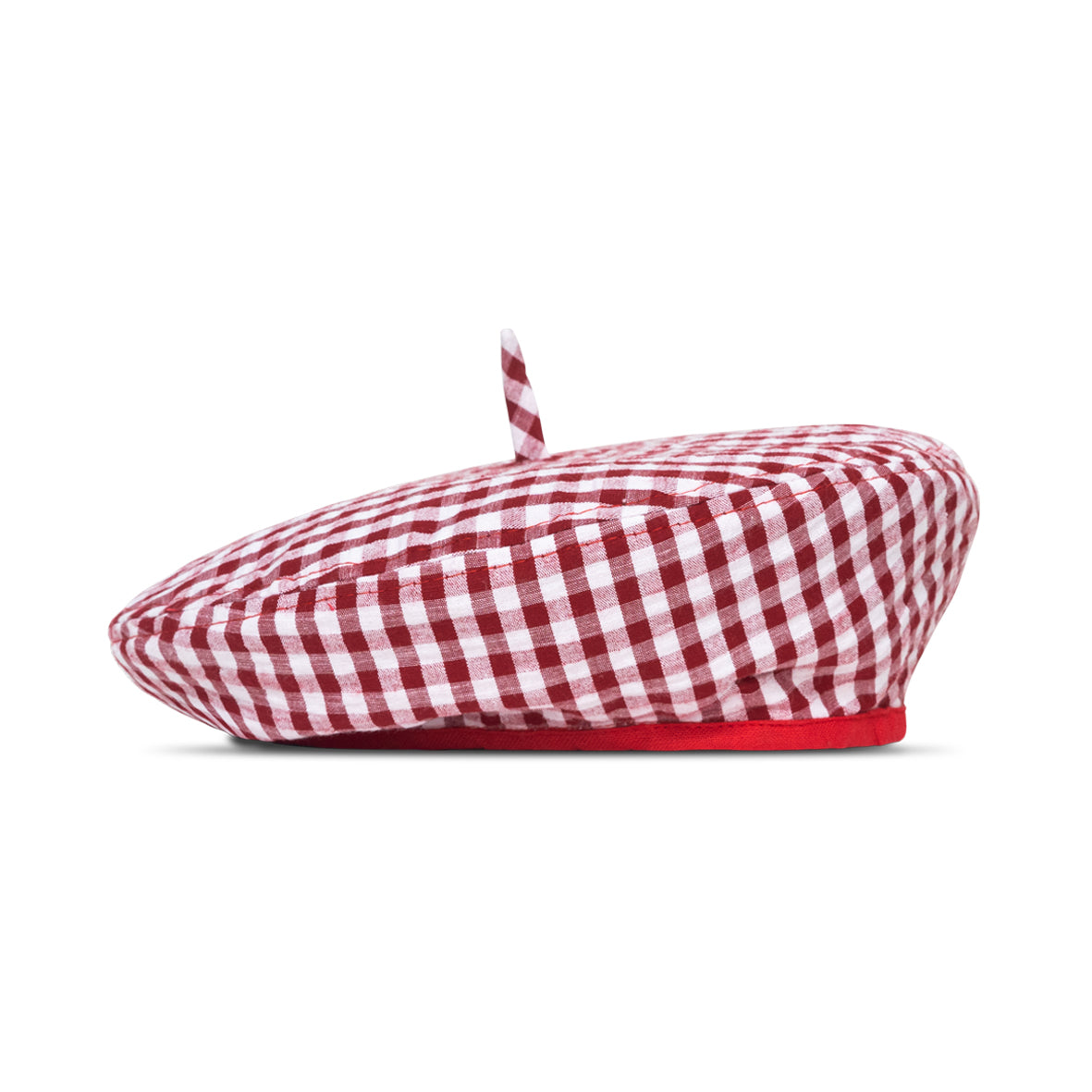 A stylish red gingham beret hat made from soft cotton with a comfortable linen lining, showcasing its eco-friendly design.