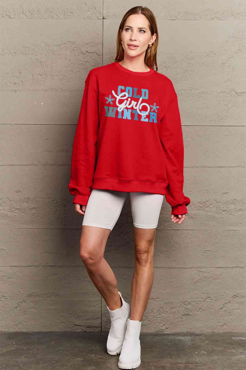 Simply Love Full Size COLD WINTER Graphic Long Sleeve Sweatshirt in a cozy setting, showcasing its stylish design and comfortable fit.