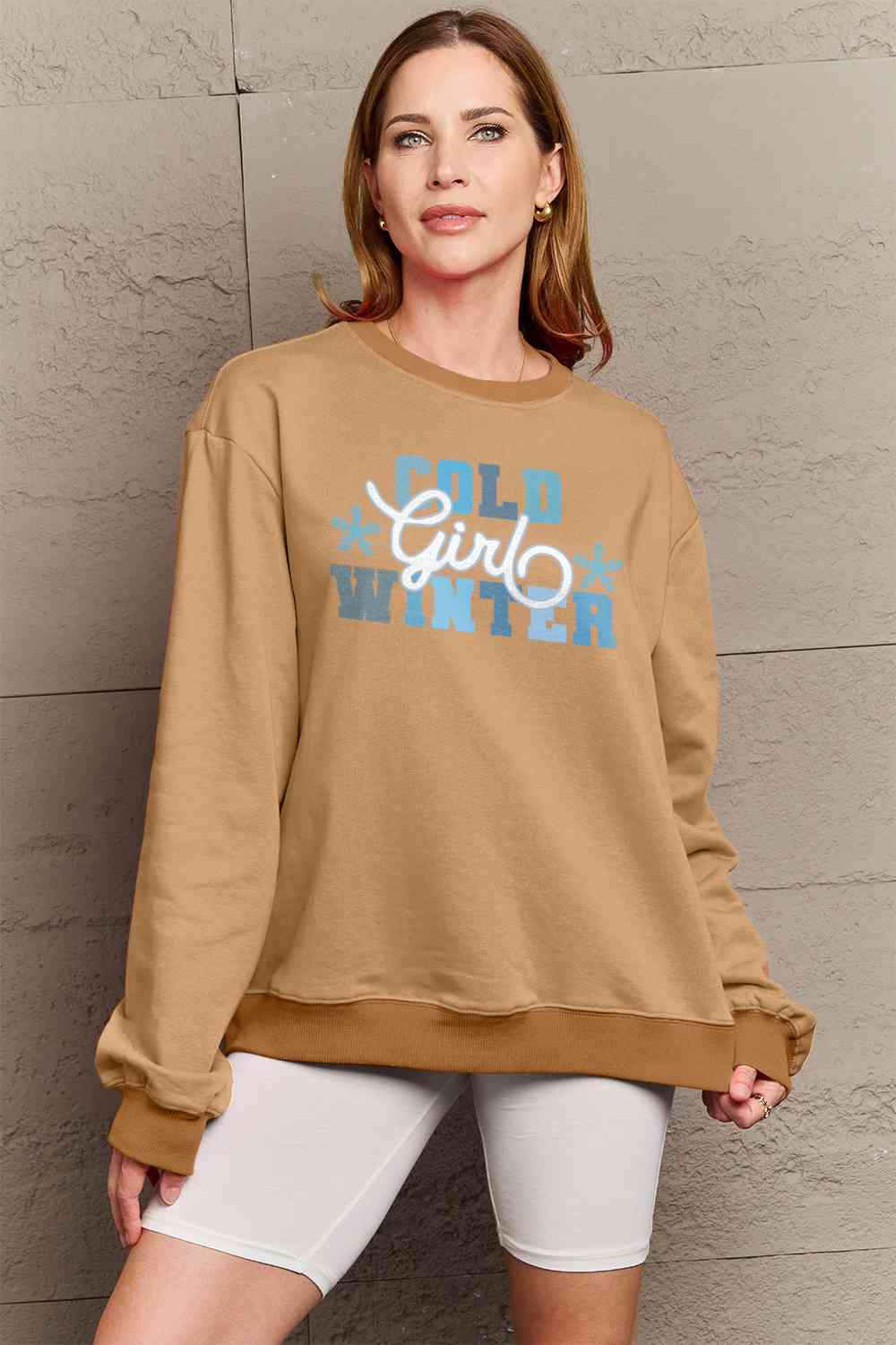 Simply Love Full Size COLD WINTER Graphic Long Sleeve Sweatshirt in a cozy setting, showcasing its stylish design and comfortable fit.