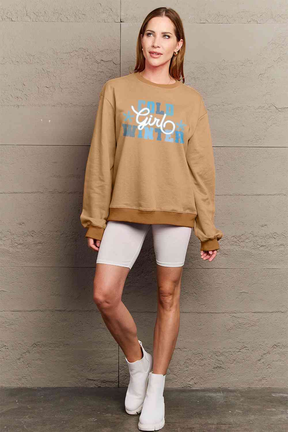 Simply Love Full Size COLD WINTER Graphic Long Sleeve Sweatshirt in a cozy setting, showcasing its stylish design and comfortable fit.