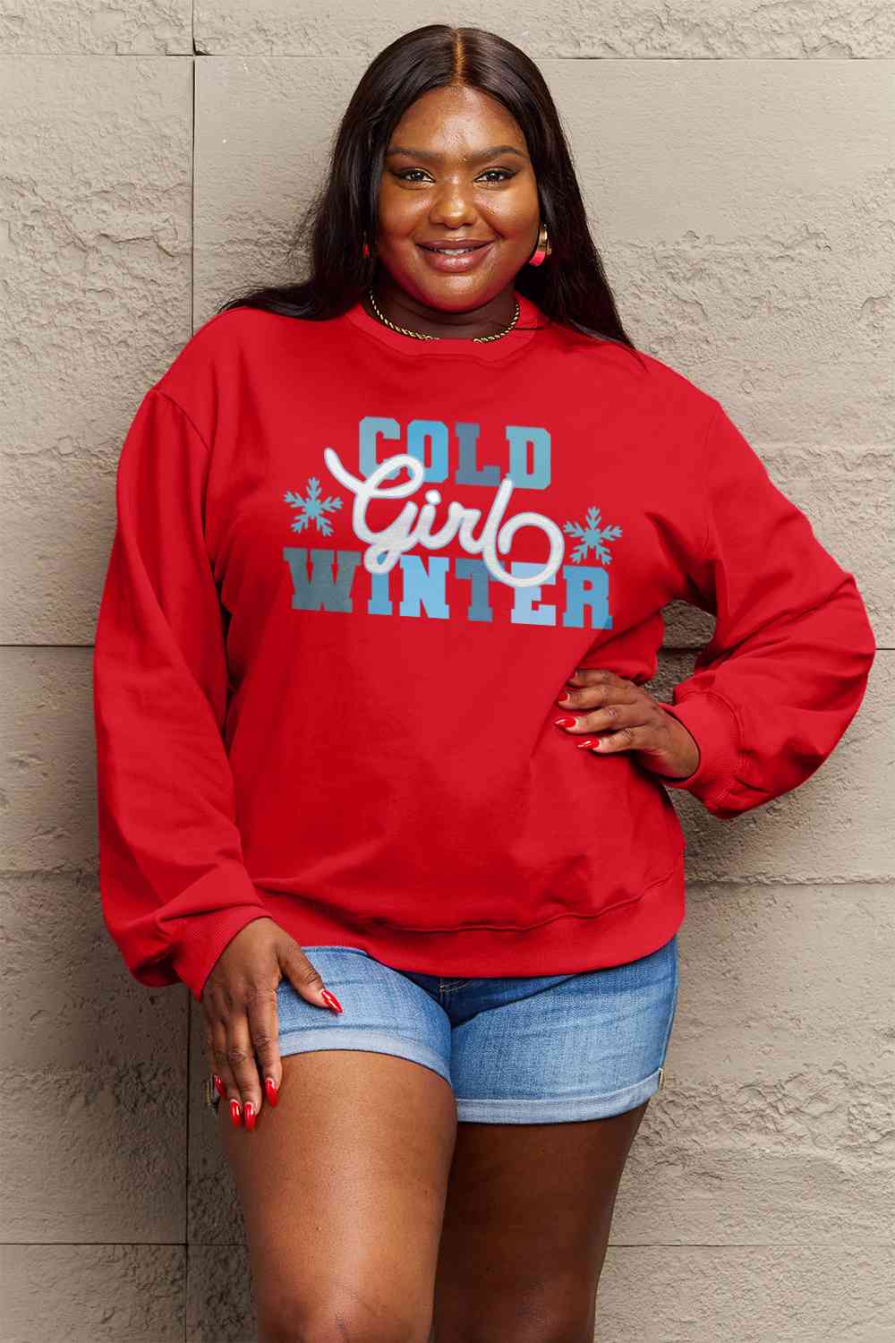 Simply Love Full Size COLD WINTER Graphic Long Sleeve Sweatshirt in a cozy setting, showcasing its stylish design and comfortable fit.