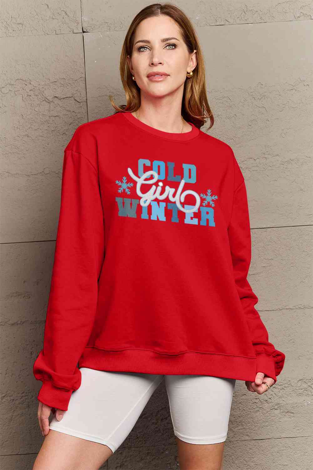 Simply Love Full Size COLD WINTER Graphic Long Sleeve Sweatshirt in a cozy setting, showcasing its stylish design and comfortable fit.