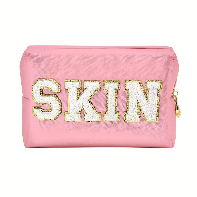 A stylish pink SKIN Cosmetic Bag, perfect for organizing makeup and beauty products while traveling.