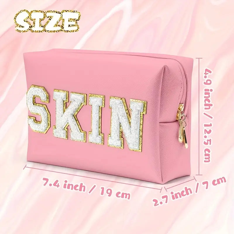 A stylish pink SKIN Cosmetic Bag, perfect for organizing makeup and beauty products while traveling.