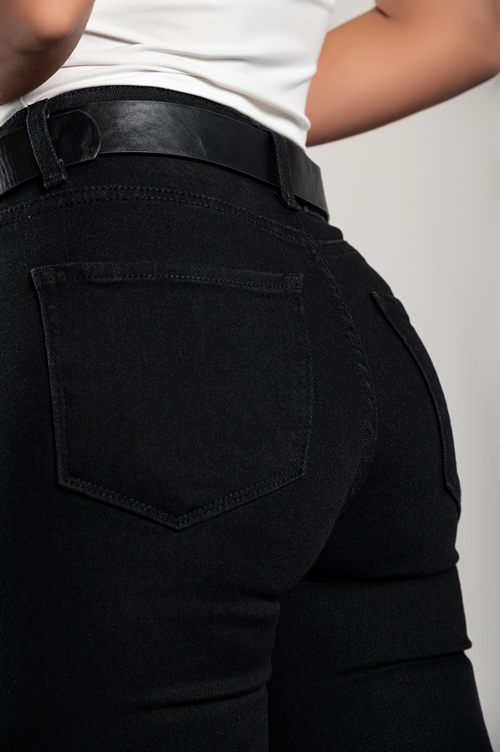 A pair of black skinny stretch jeans featuring a tapered leg, front and back pockets, zip and button closure, made from high-quality cotton.