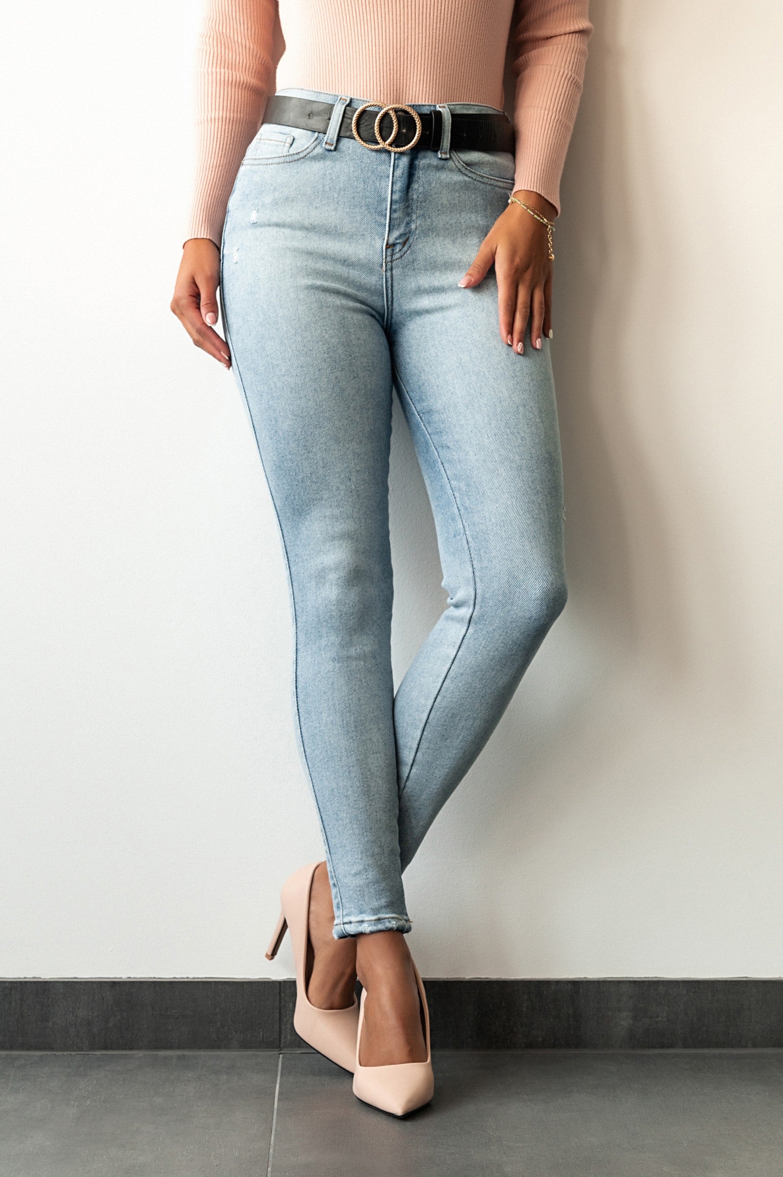 Light blue skinny stretch jeans with tapered leg design, front and back pockets, zip and button closure.