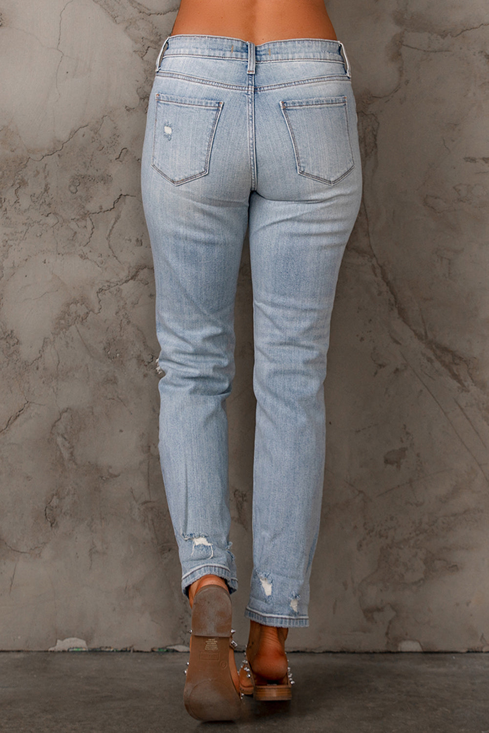 Sky Blue Ripped Mid Waist Jeans featuring a vintage acid-washed look with stylish ripped details.