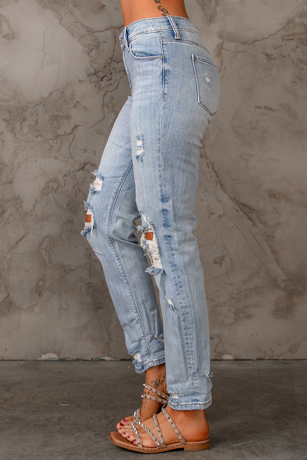 Sky Blue Ripped Mid Waist Jeans featuring a vintage acid-washed look with stylish ripped details.