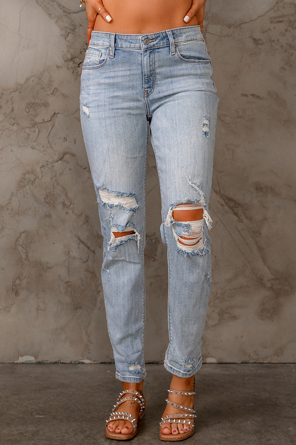 Sky Blue Ripped Mid Waist Jeans featuring a vintage acid-washed look with stylish ripped details.