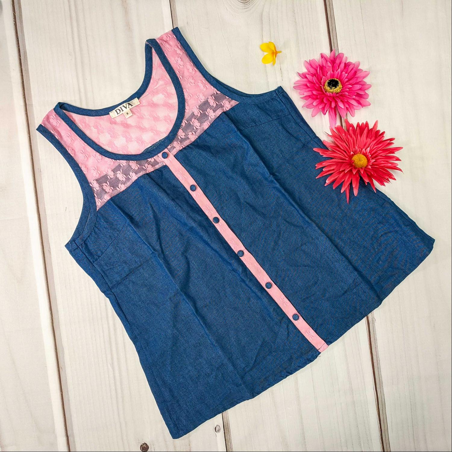 A stylish sleeveless chambray button-down sheer top featuring a lace yoke, perfect for summer outfits.