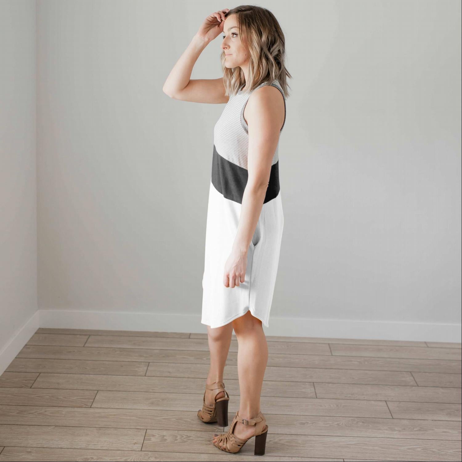 A stylish sleeveless colorblock casual dress featuring a unique design with a modest scoop neck and tulip hemline, perfect for summer outings.