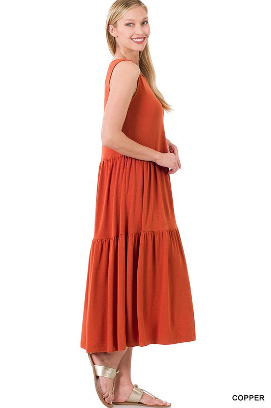 A stylish sleeveless tiered midi dress featuring a flowy ruffle skirt, available in various colors, perfect for spring and summer outings.