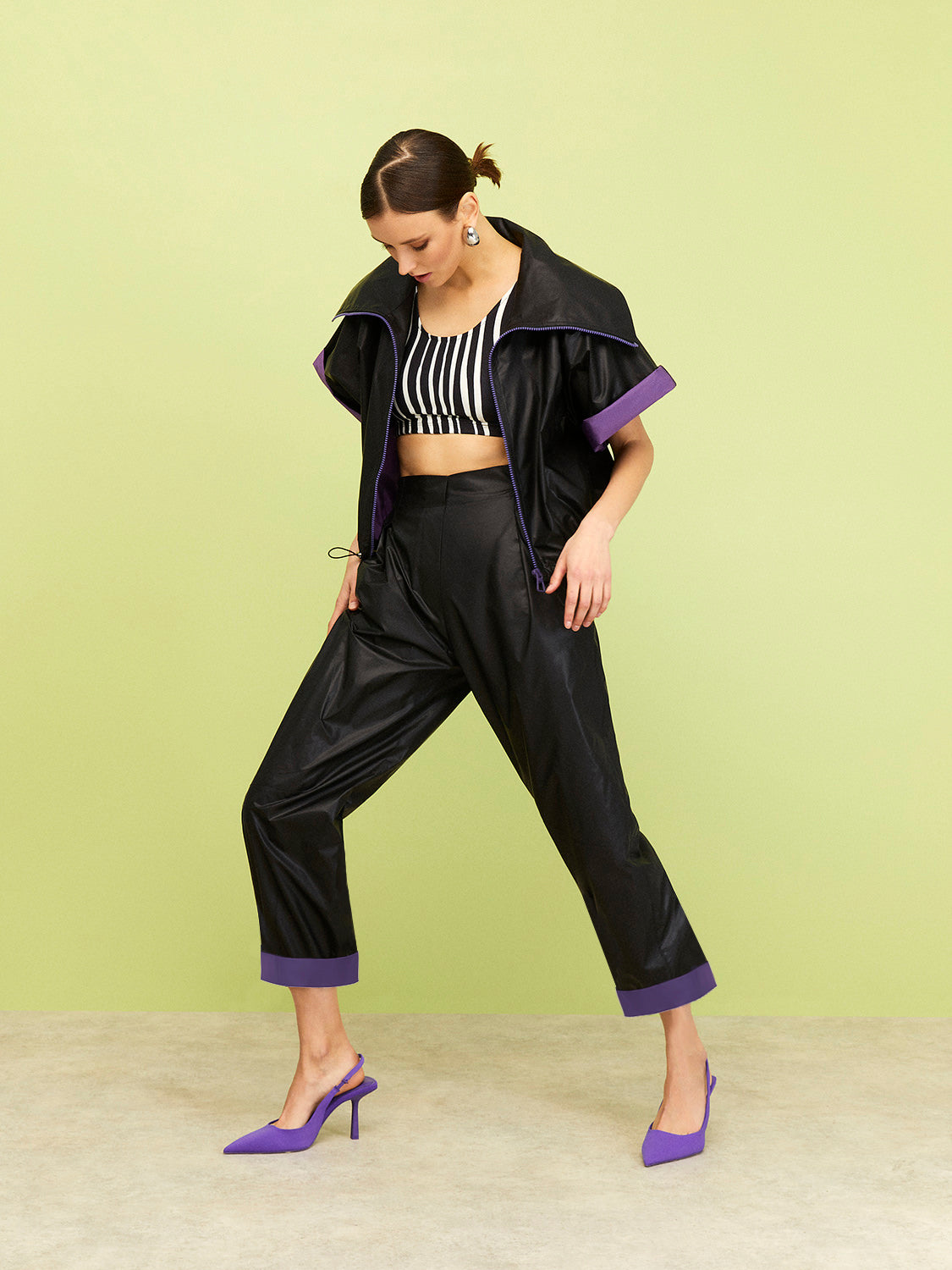 A pair of stylish slouchy cuffed pants featuring a high waist, elastic waistband, and striking zebra stripe design in black, white, and purple.