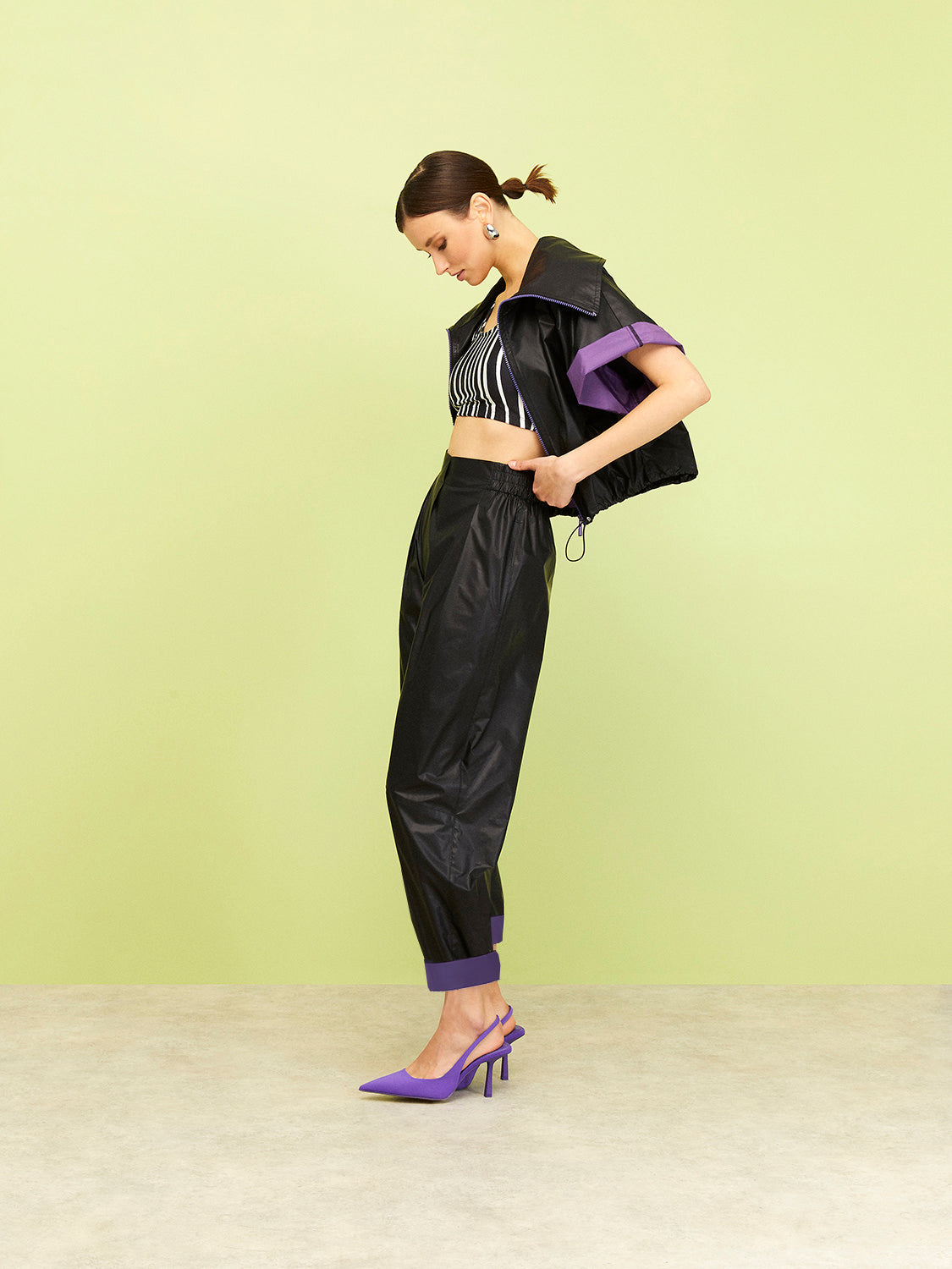 A pair of stylish slouchy cuffed pants featuring a high waist, elastic waistband, and striking zebra stripe design in black, white, and purple.