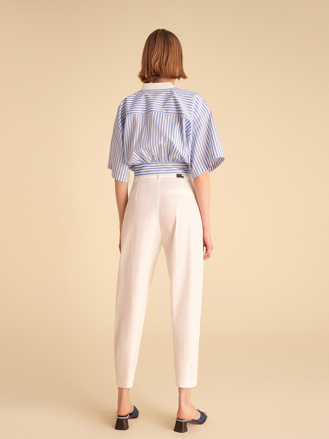 A pair of high-waisted slouchy pants with darts, featuring side pockets and a vibrant blue color, perfect for casual summer wear.