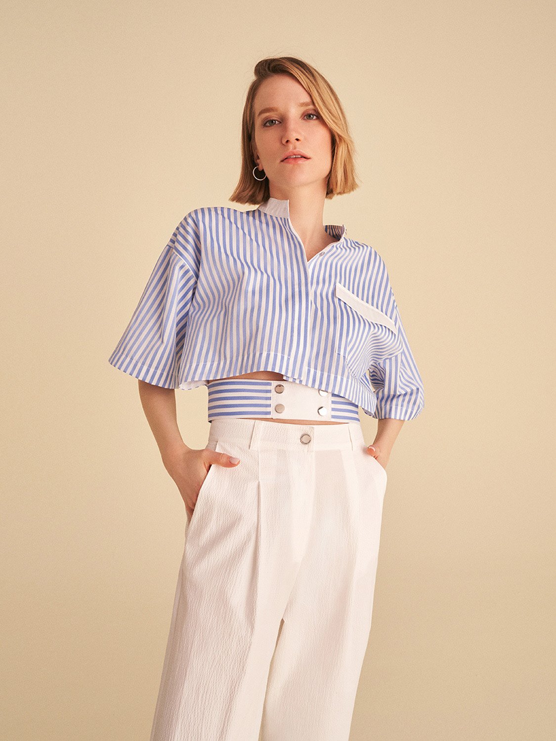 A pair of high-waisted slouchy pants with darts, featuring side pockets and a vibrant blue color, perfect for casual summer wear.