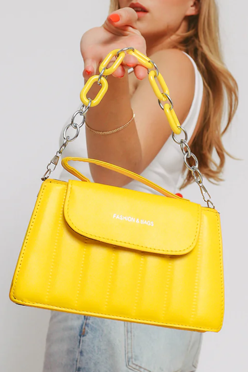 Small yellow bag ART2254 made of high-quality faux leather with a decorative chain, showcasing its elegant design.