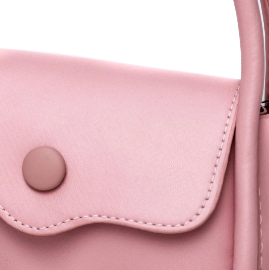 Elegant small pink bag with decorative bow, made of high-quality faux leather, featuring a snap button closure.