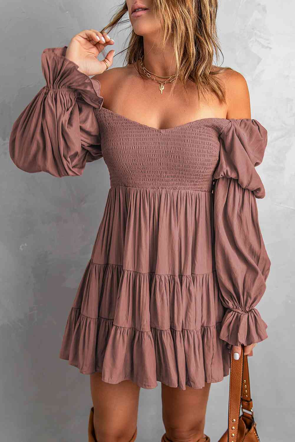 A stylish Smocked Off-Shoulder Tiered Mini Dress featuring flounce sleeves and a chic design, perfect for casual outings.