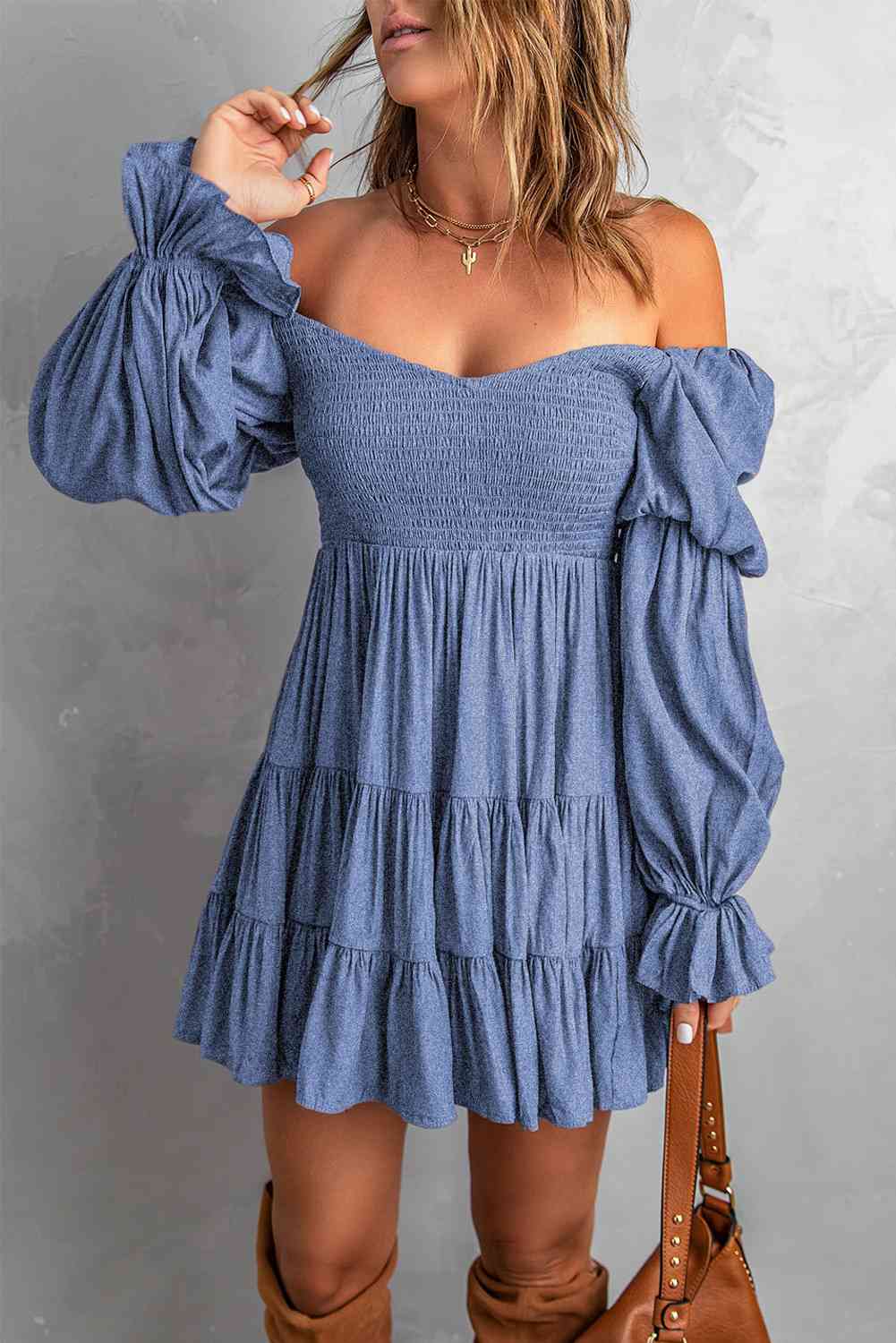 A stylish Smocked Off-Shoulder Tiered Mini Dress featuring flounce sleeves and a chic design, perfect for casual outings.