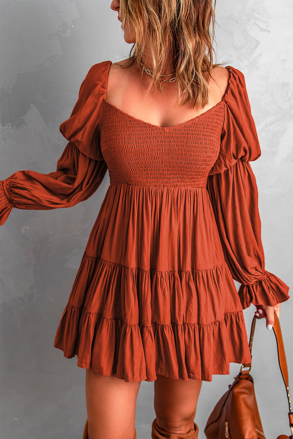 A stylish Smocked Off-Shoulder Tiered Mini Dress featuring flounce sleeves and a chic design, perfect for casual outings.