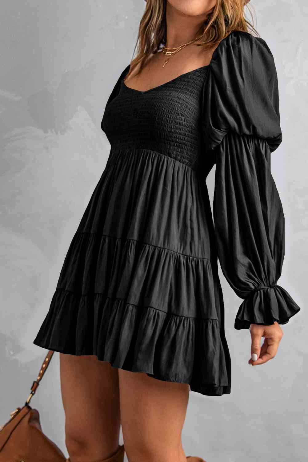 A stylish Smocked Off-Shoulder Tiered Mini Dress featuring flounce sleeves and a chic design, perfect for casual outings.