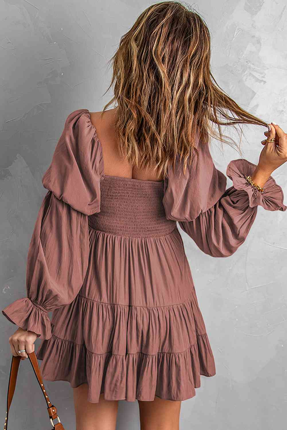 A stylish Smocked Off-Shoulder Tiered Mini Dress featuring flounce sleeves and a chic design, perfect for casual outings.