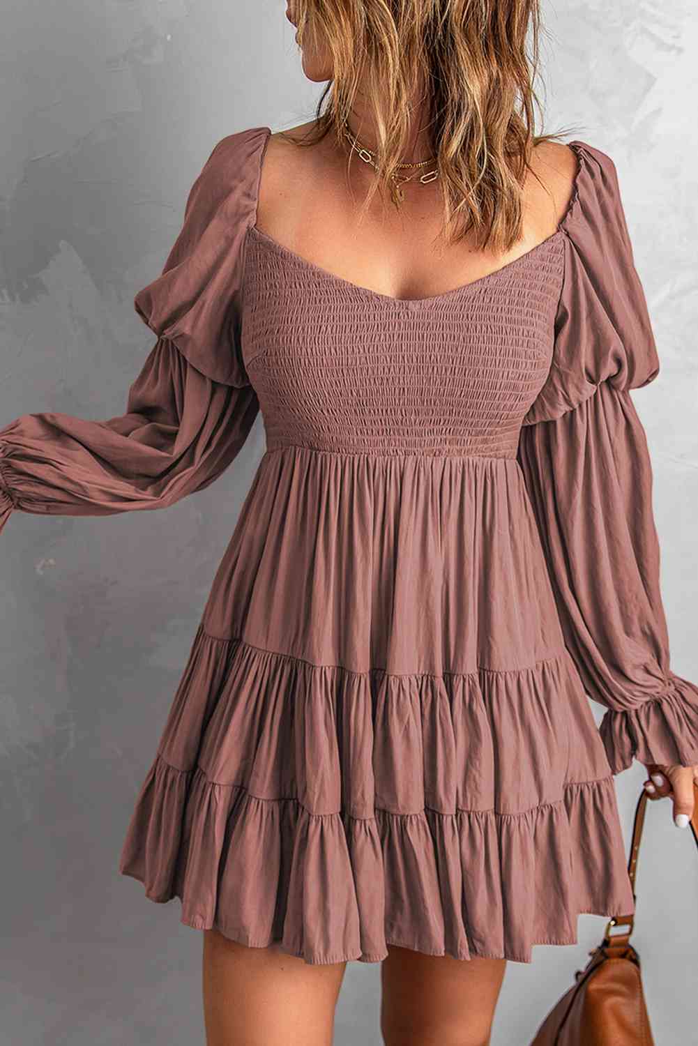 A stylish Smocked Off-Shoulder Tiered Mini Dress featuring flounce sleeves and a chic design, perfect for casual outings.