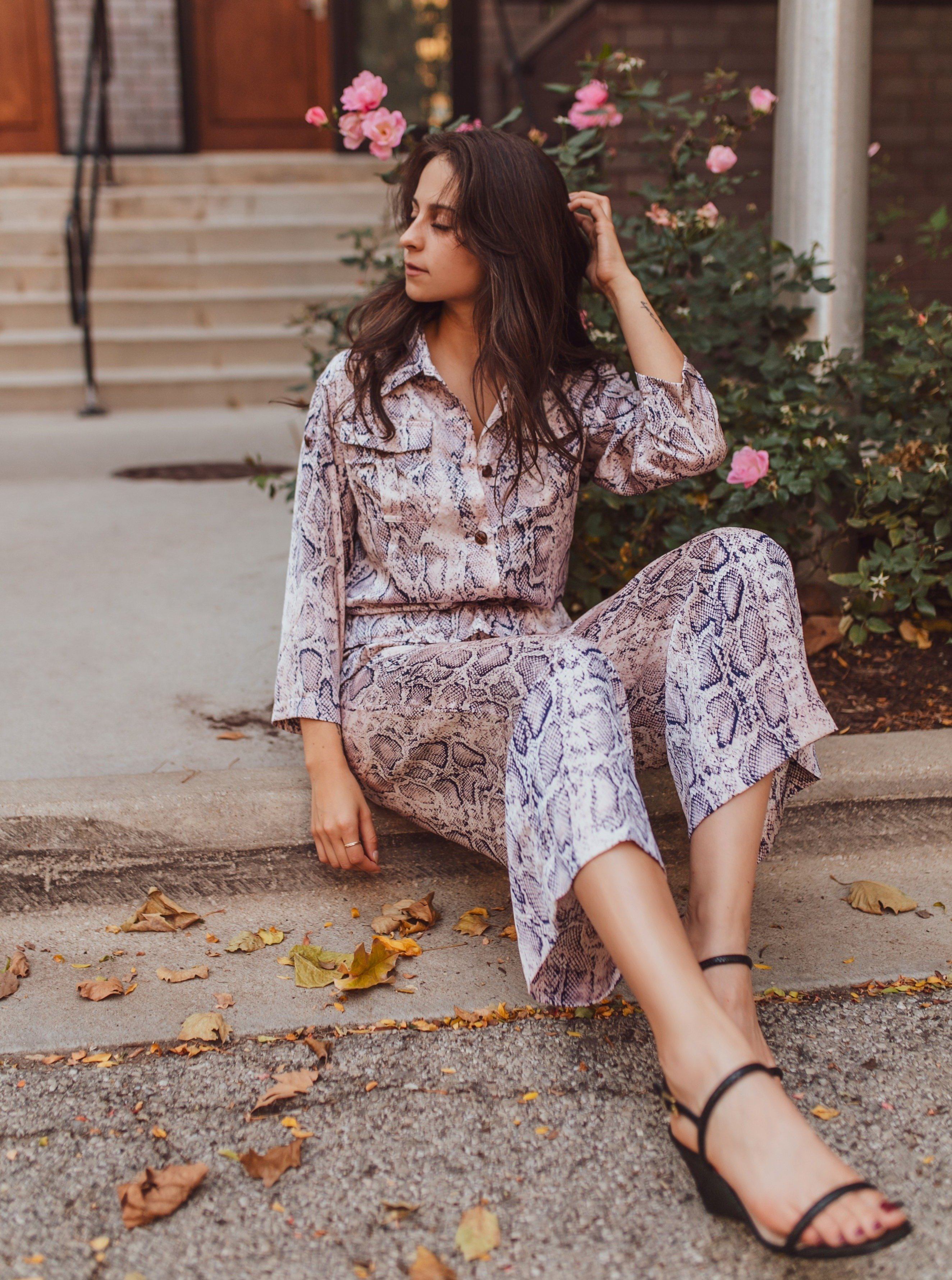 A stylish Snake A Pose Button-up Shirt Top featuring a chic snake print, V neckline, and roll-up sleeves with a detachable waist belt.