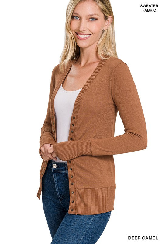 A stylish snap button sweater cardigan featuring ribbed details at the neckline, bottom, and sleeves, perfect for layering.