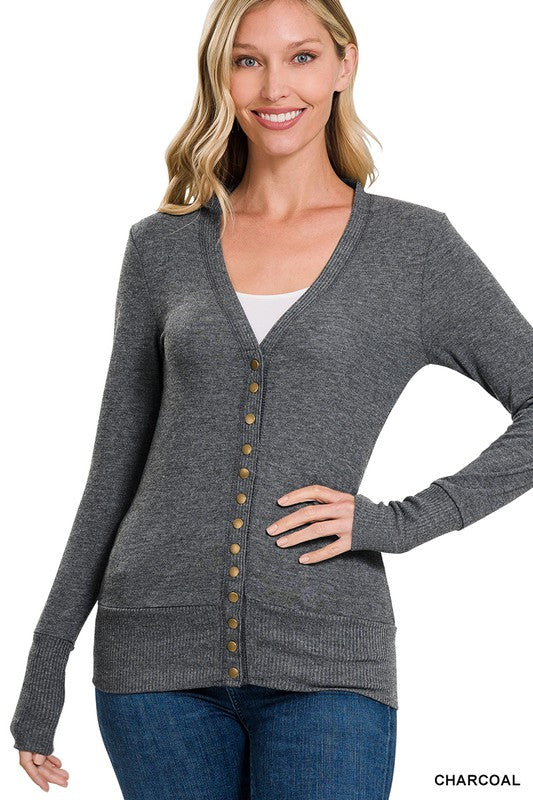 A stylish snap button sweater cardigan featuring ribbed details at the neckline, bottom, and sleeves, perfect for layering.