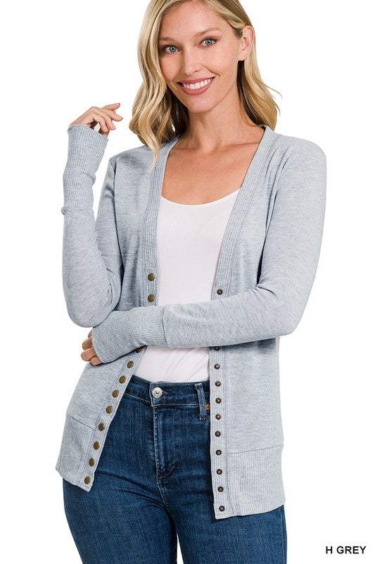 A stylish snap button sweater cardigan featuring ribbed details at the neckline, bottom, and sleeves, perfect for layering.