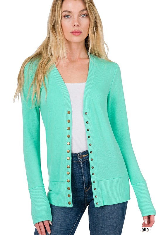 A stylish snap button sweater cardigan featuring ribbed details at the neckline, bottom, and sleeves, perfect for layering.