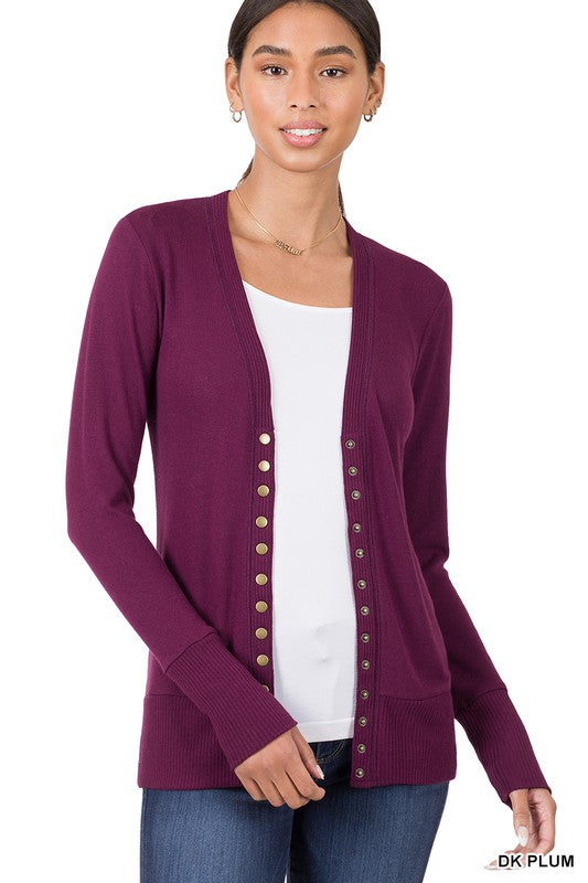 A stylish snap button sweater cardigan featuring ribbed details at the neckline, bottom, and sleeves, perfect for layering.