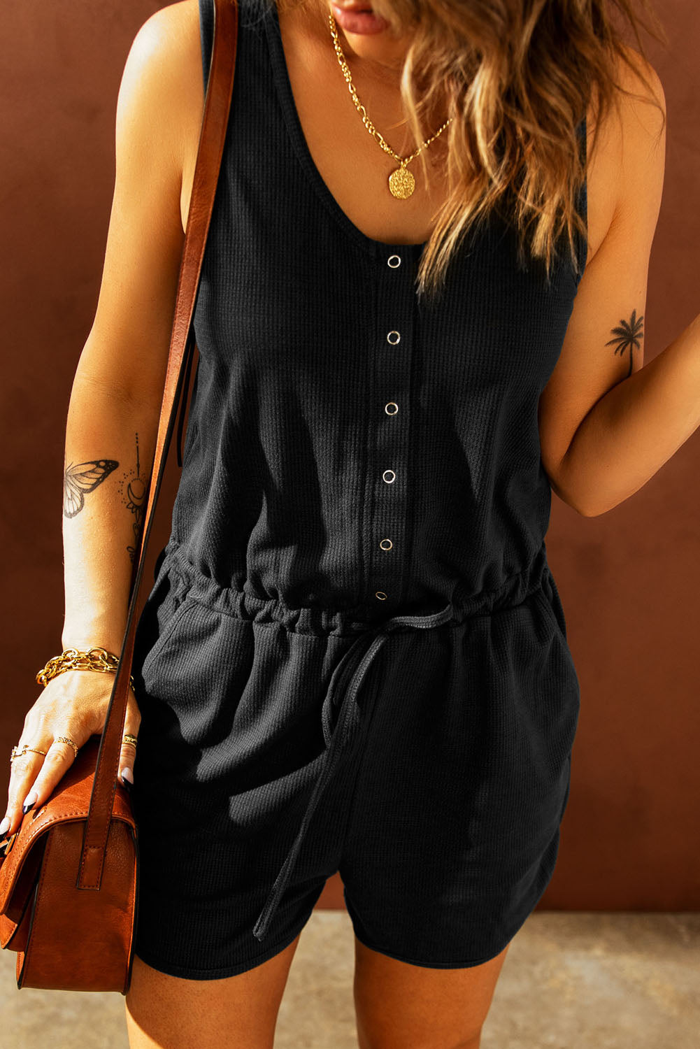 A stylish Snap Front Drawstring Waist Romper in solid color, featuring a round neck and sleeveless design, perfect for casual outings.